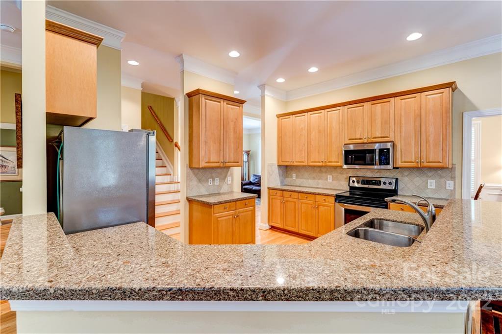 1944 Clark Elliot Street Fort Mill, SC 29708 - Photo 13 of 46 a kitchen with stainless steel appliances granite countertop a sink refrigerator and microwave