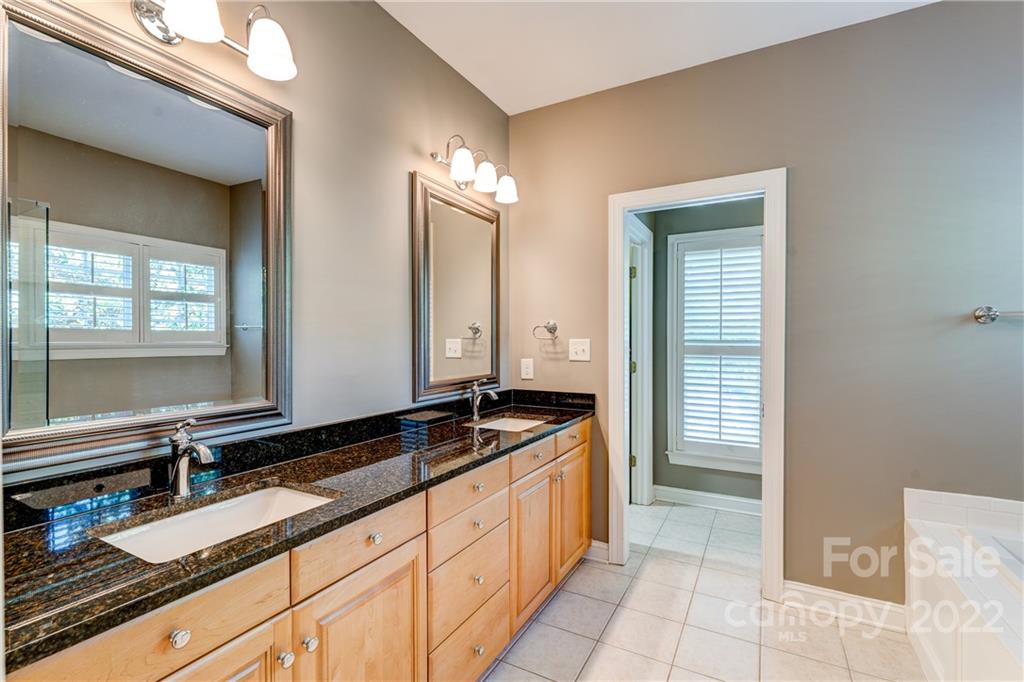 1944 Clark Elliot Street Fort Mill, SC 29708 - Photo 30 of 46 a spacious bathroom with a granite countertop sink and a mirror