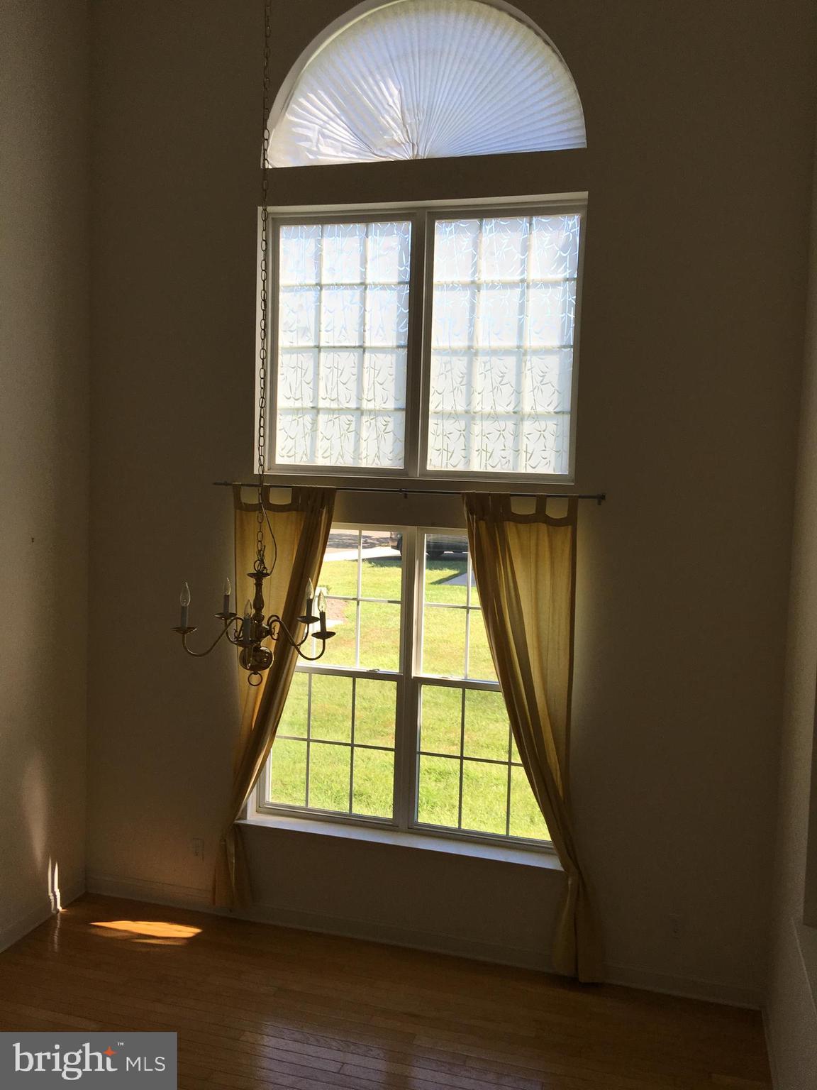46 Warwick Road Princeton Junction, NJ 08550 - Photo 4 of 21 an empty room with wooden floor and windows