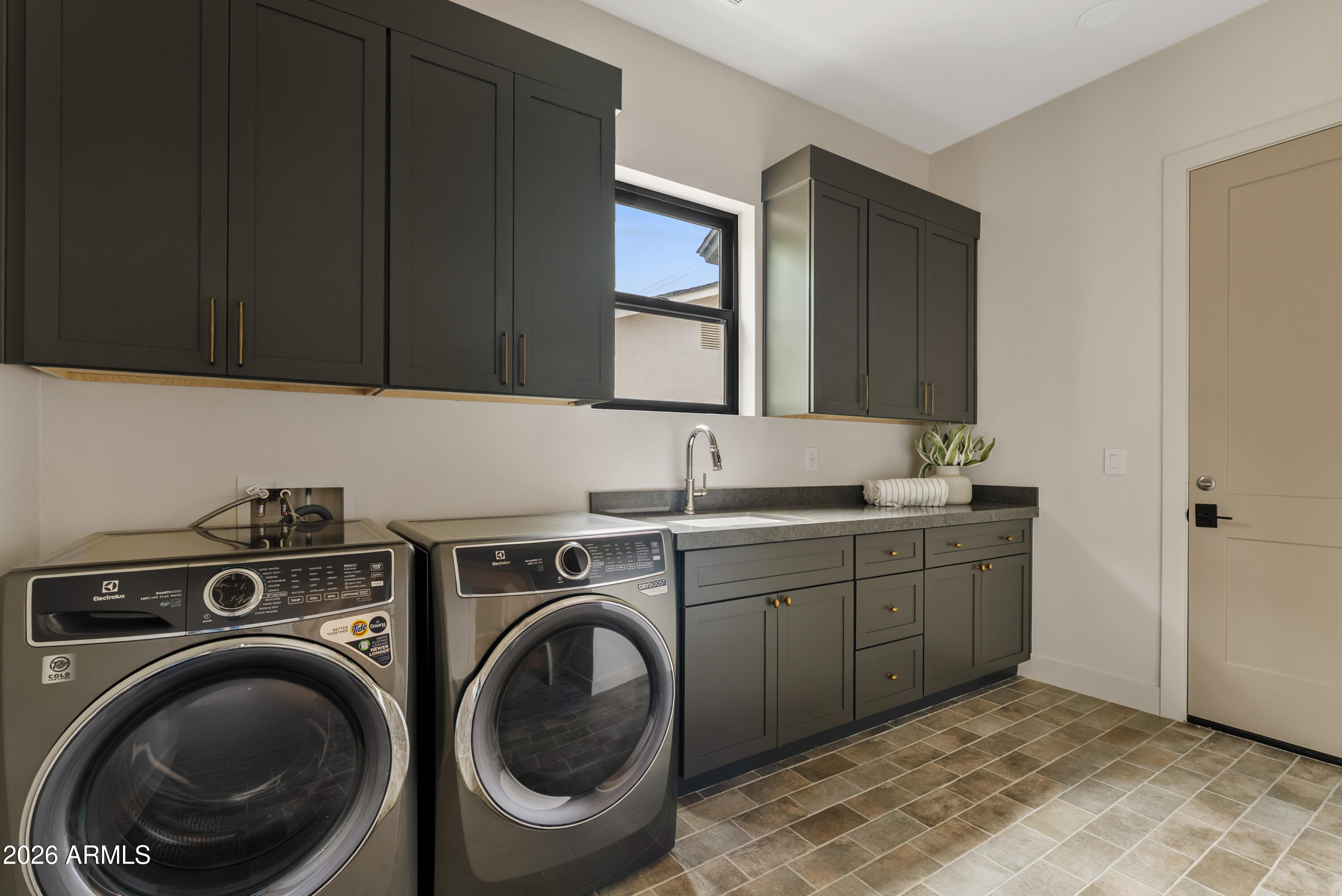 4035 East Osborn Road Phoenix, AZ 85018 - Photo 31 of 63 a bathroom with a sink and a washer dryer