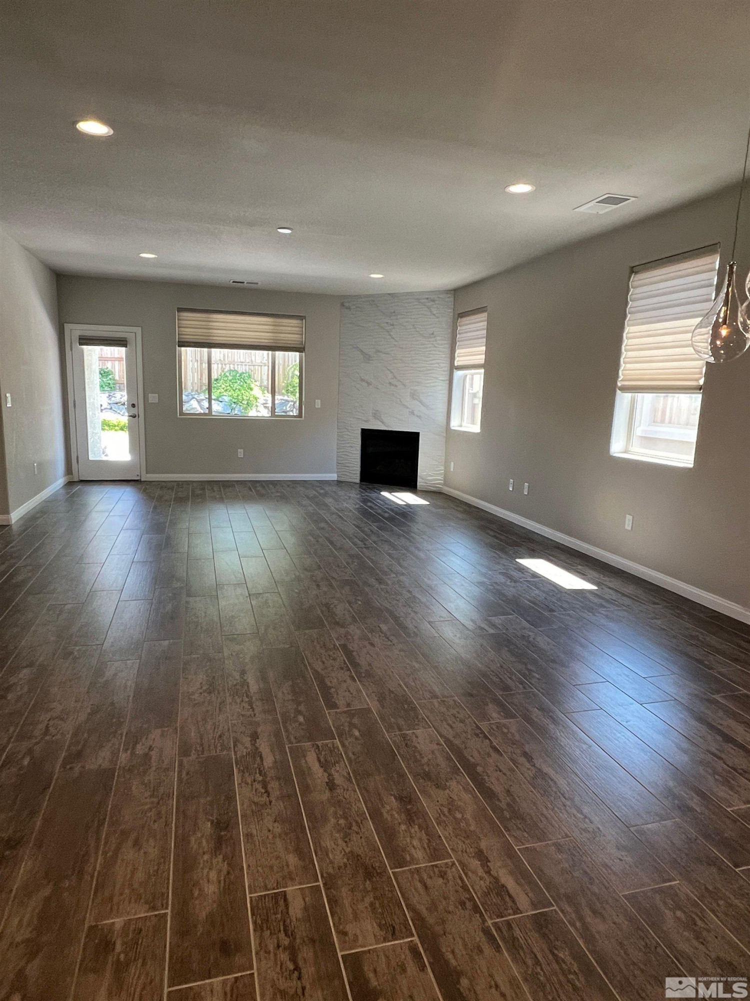 774 Sweet Briar Lane Sparks, NV 89436 - Photo 3 of 17 an empty room with wooden floor and windows