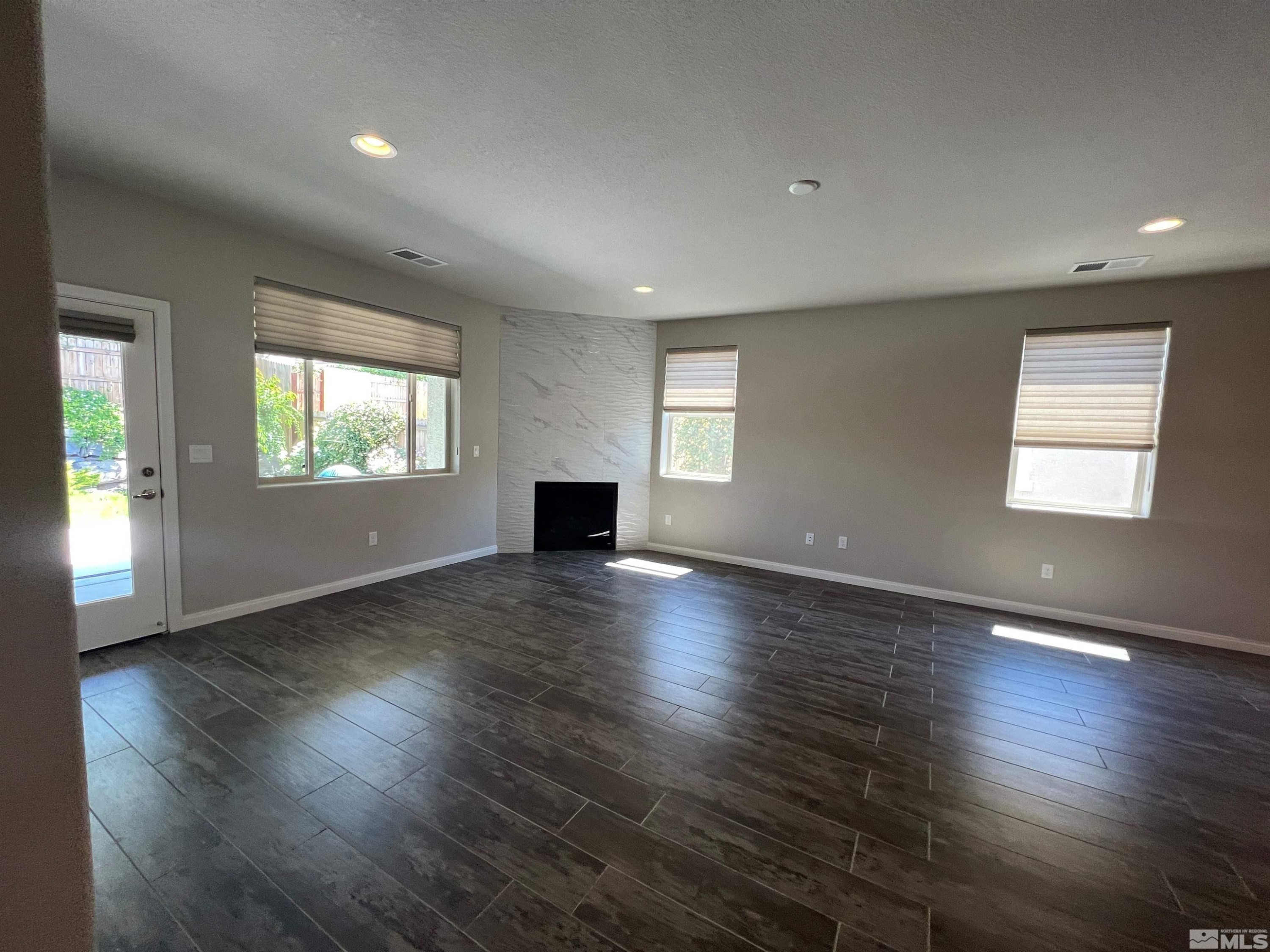 774 Sweet Briar Lane Sparks, NV 89436 - Photo 4 of 17 an empty room with wooden floor and windows