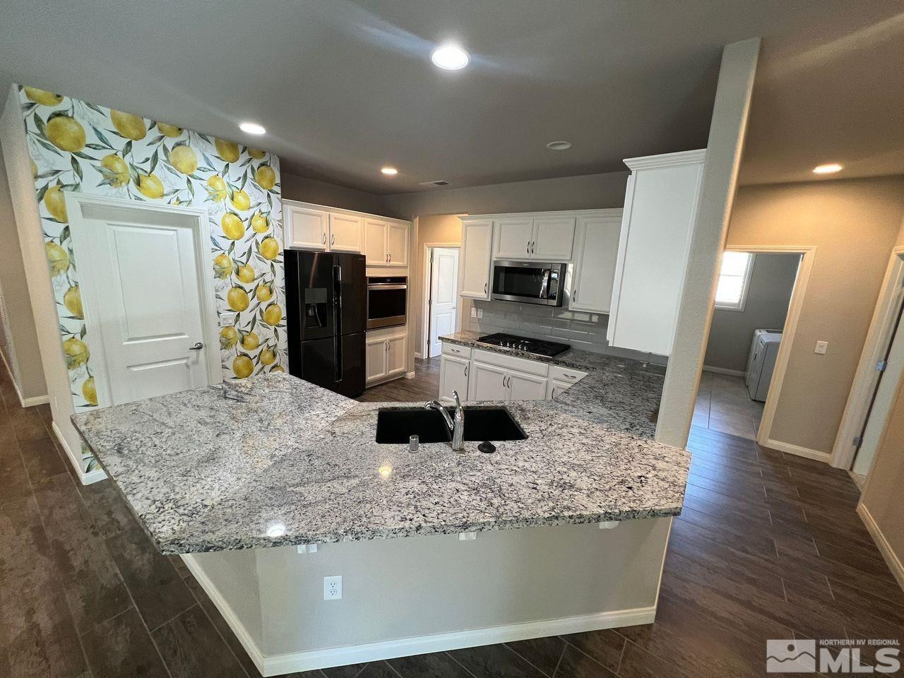 774 Sweet Briar Lane Sparks, NV 89436 - Photo 8 of 17 a kitchen with stainless steel appliances granite countertop a refrigerator and a sink