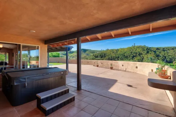 a living room with patio furniture and a floor to ceiling window