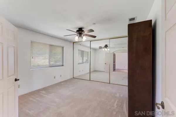 a bedroom with a bed a desk and chair