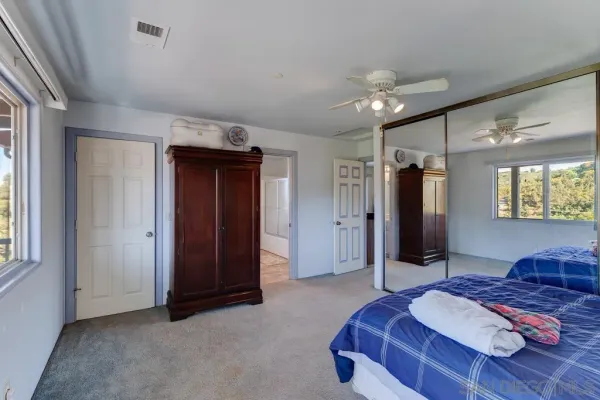 a spacious bedroom with a bed and window