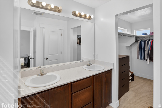 815 West Powderwood Lane Mapleton, UT 84664 - Photo 24 of 39 Bathroom with double vanity, a spacious closet, light colored carpet, and ensuite bathroom
