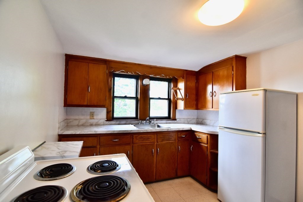 20 Hollis Avenue, Unit 5 Quincy, MA 02171 - Photo 11 of 14 a kitchen with a refrigerator and a sink