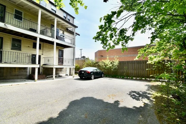 a view of a street with a building in the background