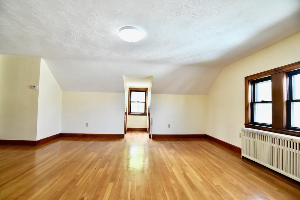 20 Hollis Avenue, Unit 5 Quincy, MA 02171 - Photo 2 of 14 an empty room with wooden floor and windows