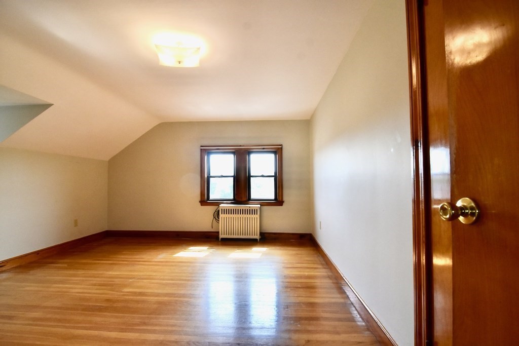 20 Hollis Avenue, Unit 5 Quincy, MA 02171 - Photo 3 of 14 wooden floor in an empty room with a window