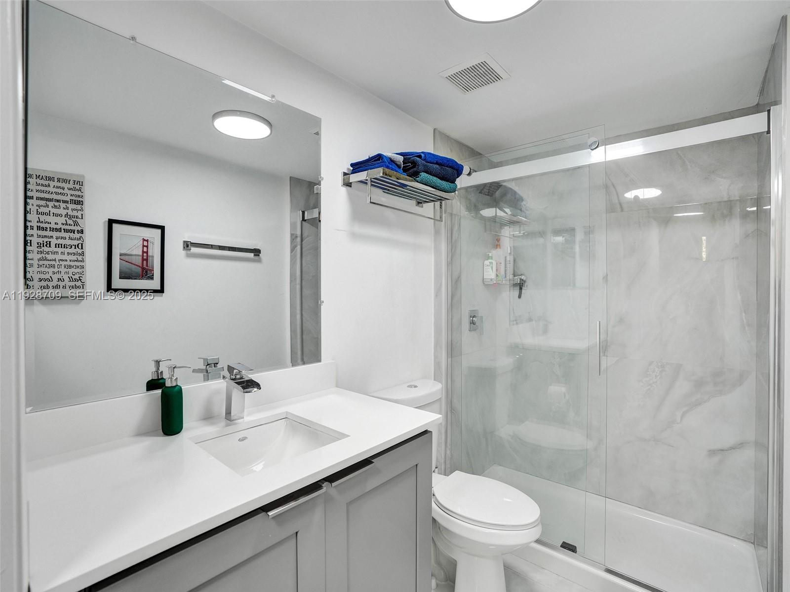 9470 Tangerine Place, Unit 207 Davie, FL 33324 - Photo 4 of 14 a bathroom with a sink a toilet and shower