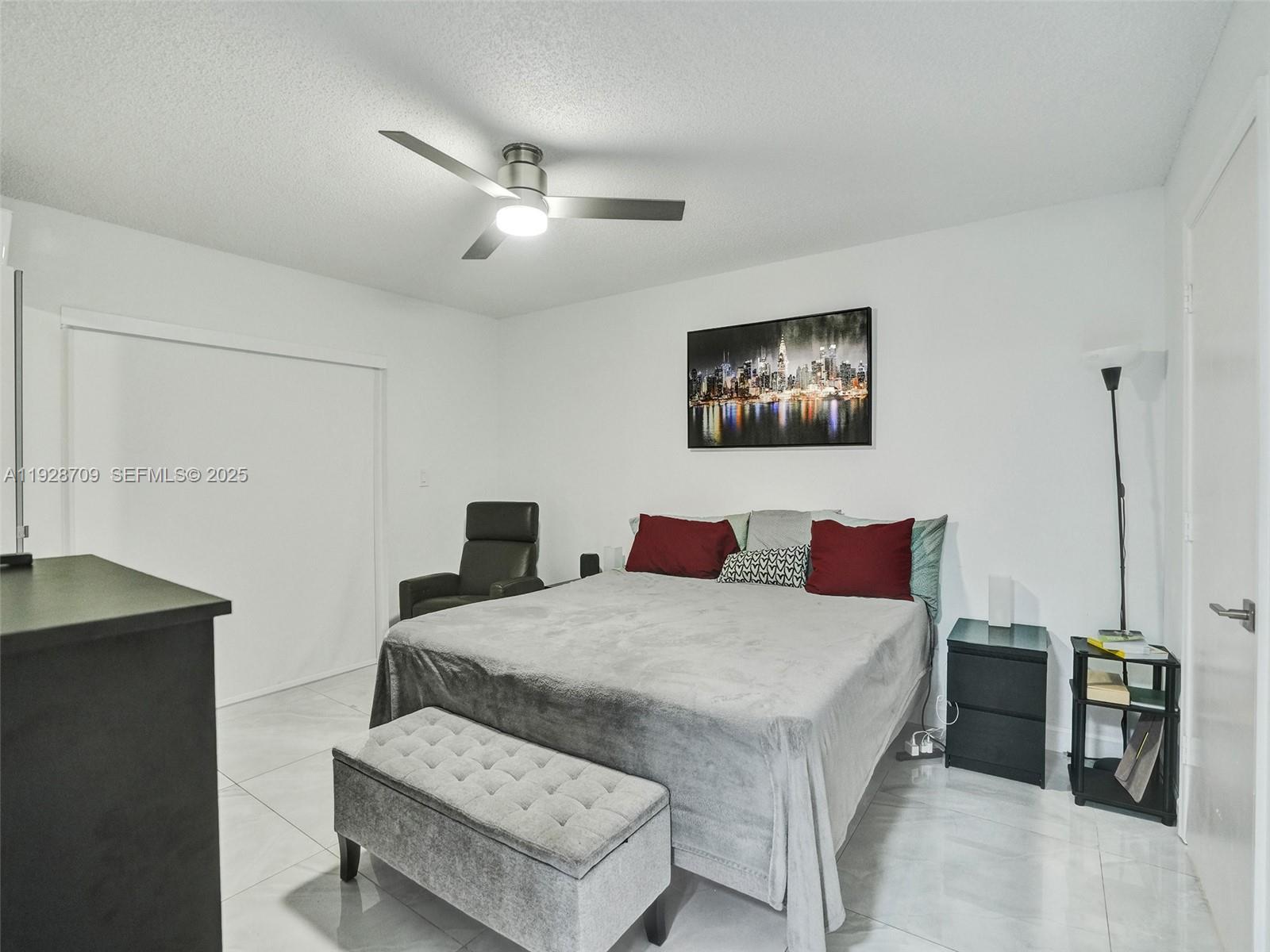 9470 Tangerine Place, Unit 207 Davie, FL 33324 - Photo 10 of 14 a living room with a bed and furniture