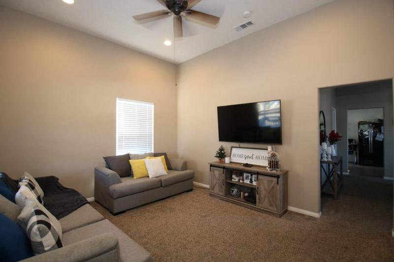 1127 K Street Reedley, CA 93654 - Photo 5 of 22 a living room with furniture and a flat screen tv