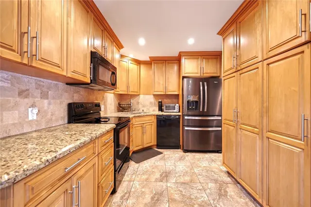a kitchen with a refrigerator sink and stove