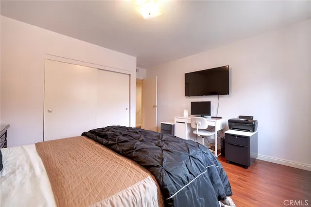 a bedroom with a bed and a flat screen tv