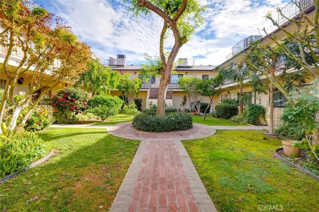 a view of a fountain in front of a house with a big yard