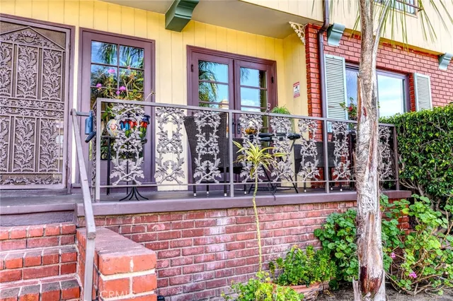 front view of brick house with potted plants