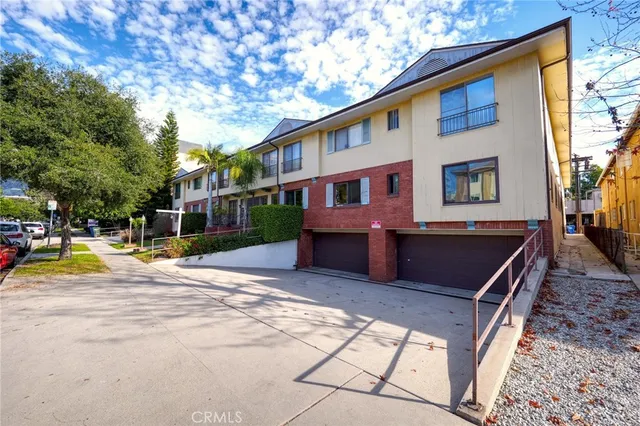 a view of a house with pool and chairs