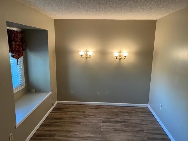 4795 Winchester Road Memphis, TN 38118 - Photo 6 of 7 Interior space featuring wood-finish flooring, two wall sconces, a window niche with a built-in bench, and neutral-toned walls