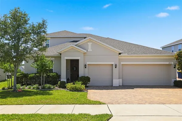 a front view of a house with a yard and garage