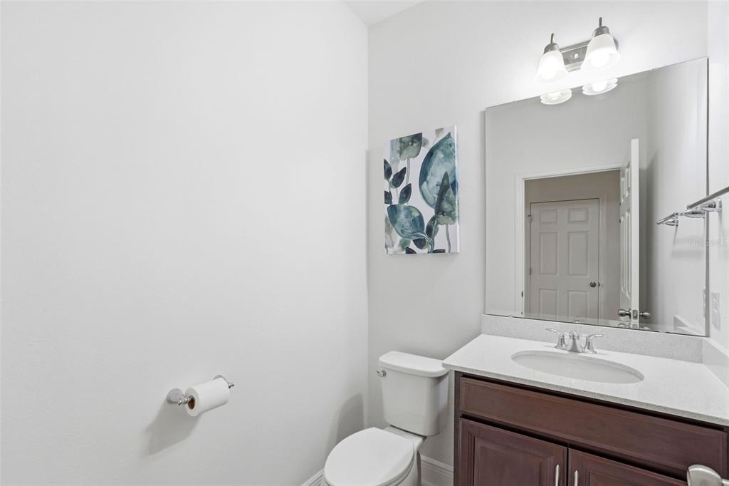 1433 Shira Road Minneola, FL 34715 - Photo 11 of 40 a bathroom with a toilet sink and mirror