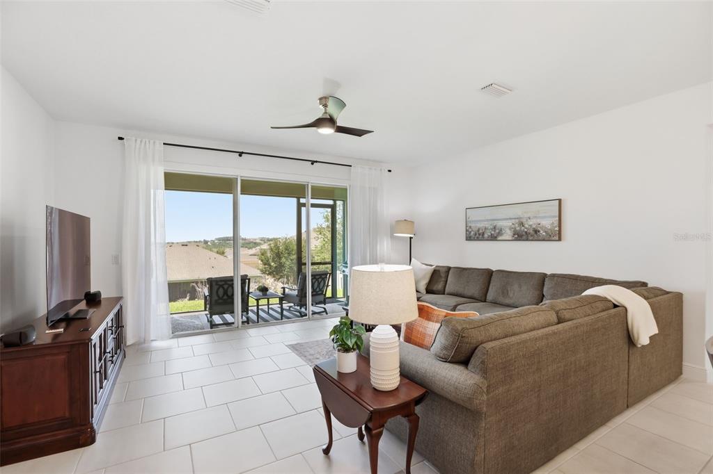 1433 Shira Road Minneola, FL 34715 - Photo 13 of 40 a living room with furniture and a flat screen tv