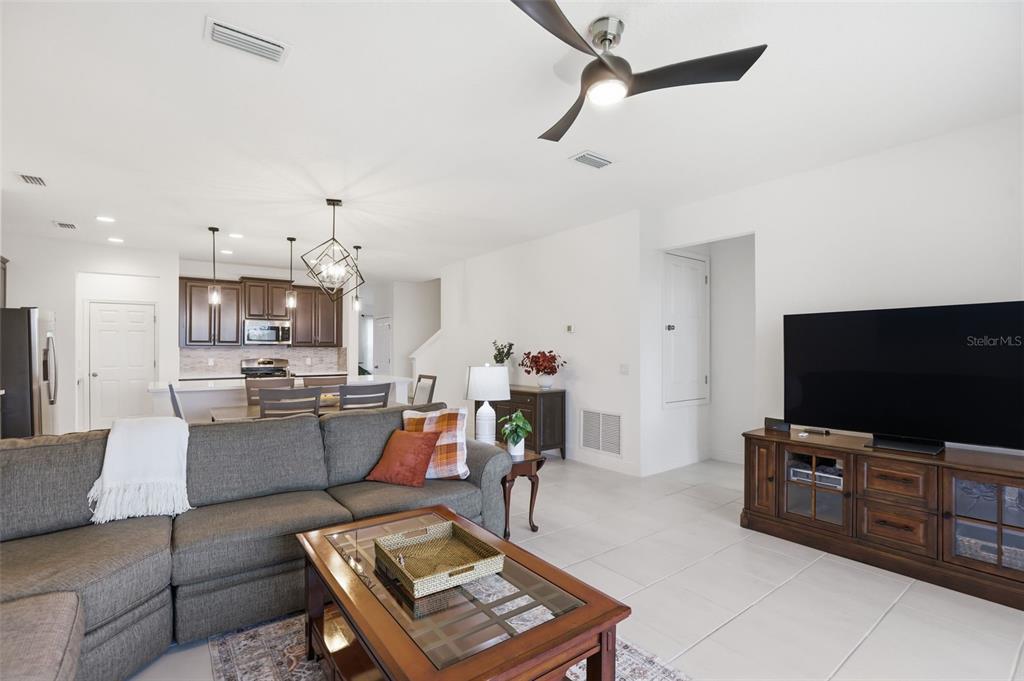1433 Shira Road Minneola, FL 34715 - Photo 15 of 40 a living room with furniture and a flat screen tv