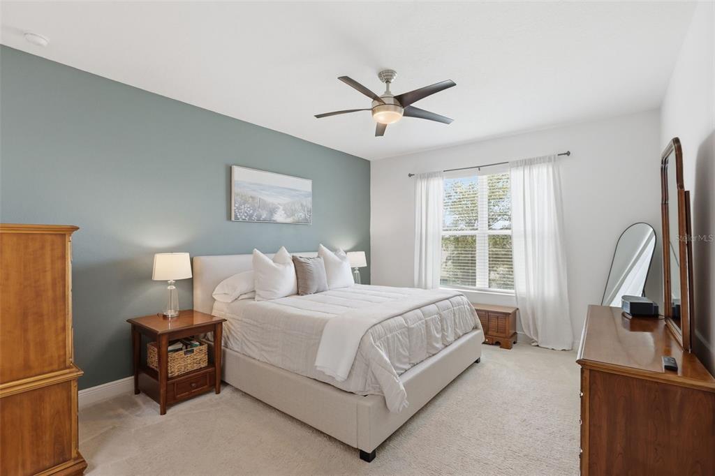 1433 Shira Road Minneola, FL 34715 - Photo 18 of 40 a bedroom with a bed a large window and flat screen tv