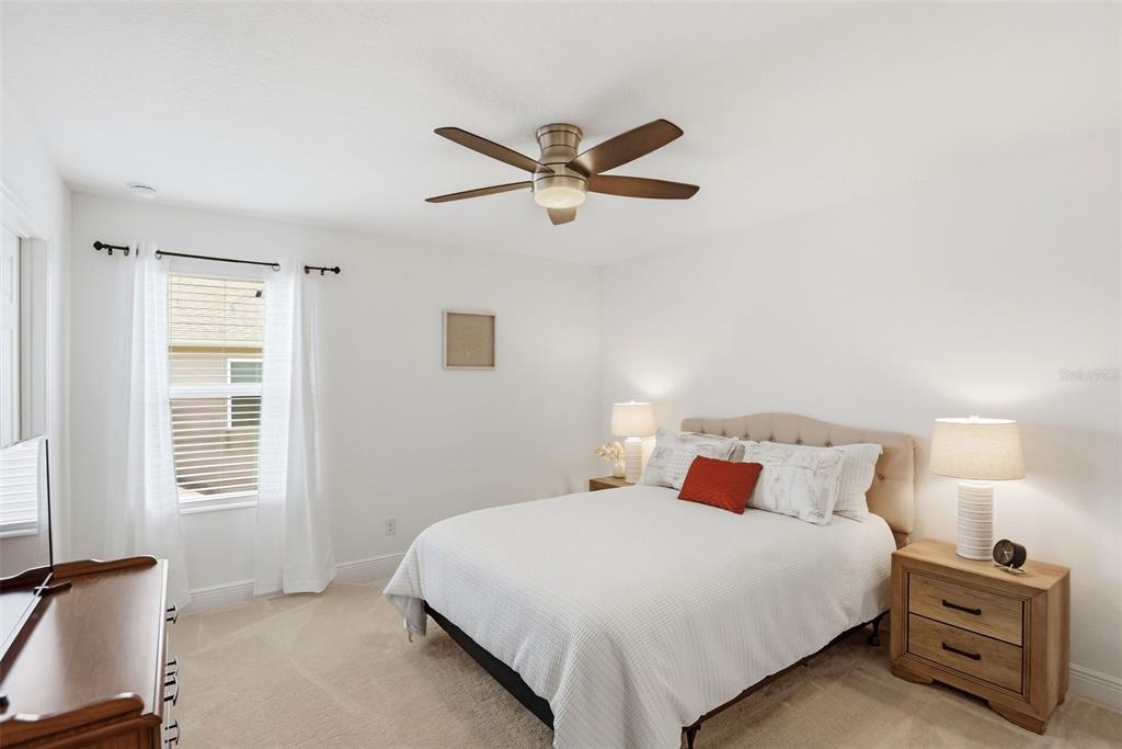 1433 Shira Road Minneola, FL 34715 - Photo 21 of 40 a bedroom with a bed and a window