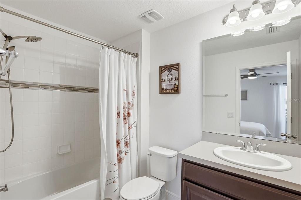 1433 Shira Road Minneola, FL 34715 - Photo 22 of 40 a bathroom with a sink toilet and shower