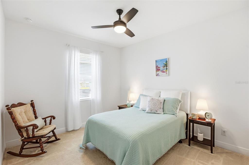 1433 Shira Road Minneola, FL 34715 - Photo 23 of 40 a bedroom with a bed chair and window