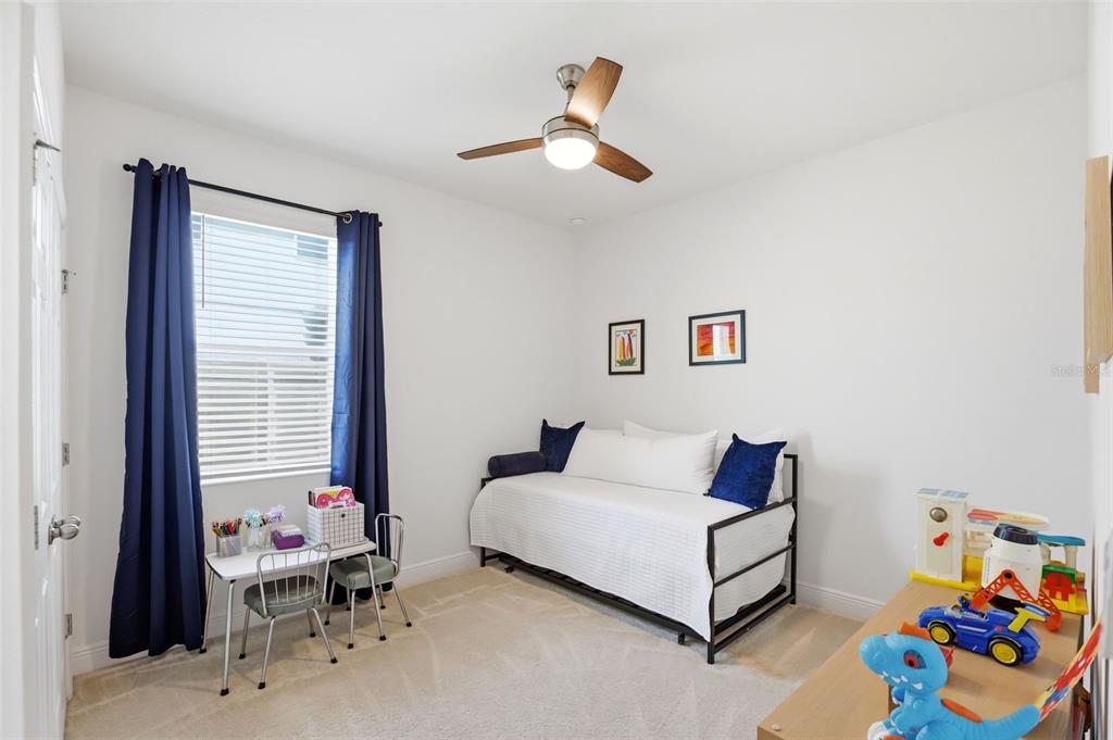 1433 Shira Road Minneola, FL 34715 - Photo 25 of 40 a bedroom with a bed and a couch