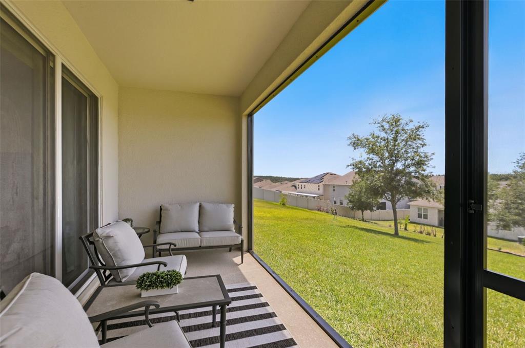 1433 Shira Road Minneola, FL 34715 - Photo 30 of 40 a view of a balcony with chair and table