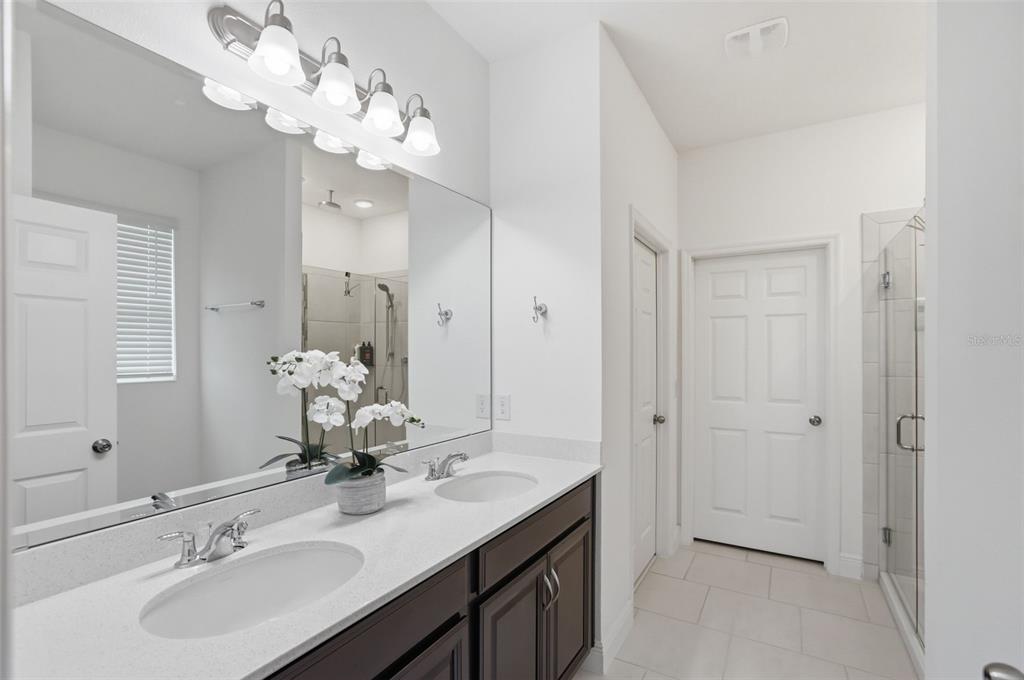 1433 Shira Road Minneola, FL 34715 - Photo 3 of 40 a bathroom with a sink vanity and a mirror