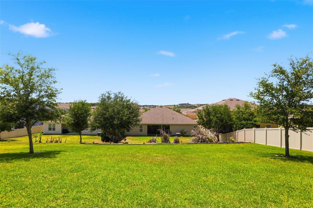 1433 Shira Road Minneola, FL 34715 - Photo 31 of 40 a view of a house with a yard