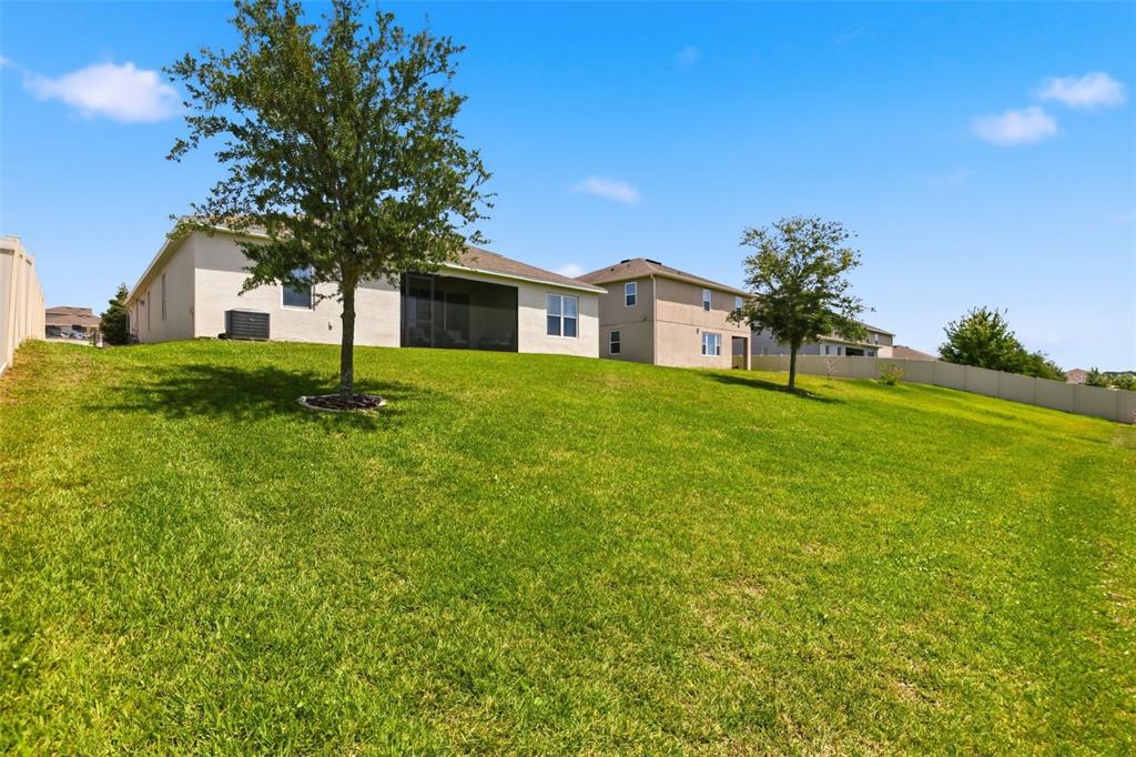 1433 Shira Road Minneola, FL 34715 - Photo 33 of 40 a front view of a house with a garden