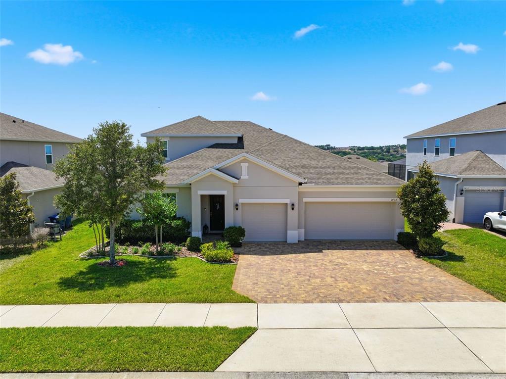 1433 Shira Road Minneola, FL 34715 - Photo 37 of 40 a front view of house with yard and green space