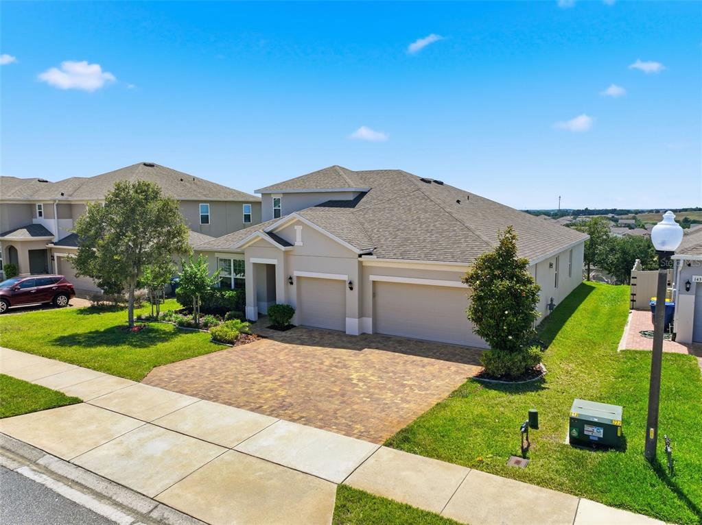 1433 Shira Road Minneola, FL 34715 - Photo 38 of 40 a front view of a house with garden