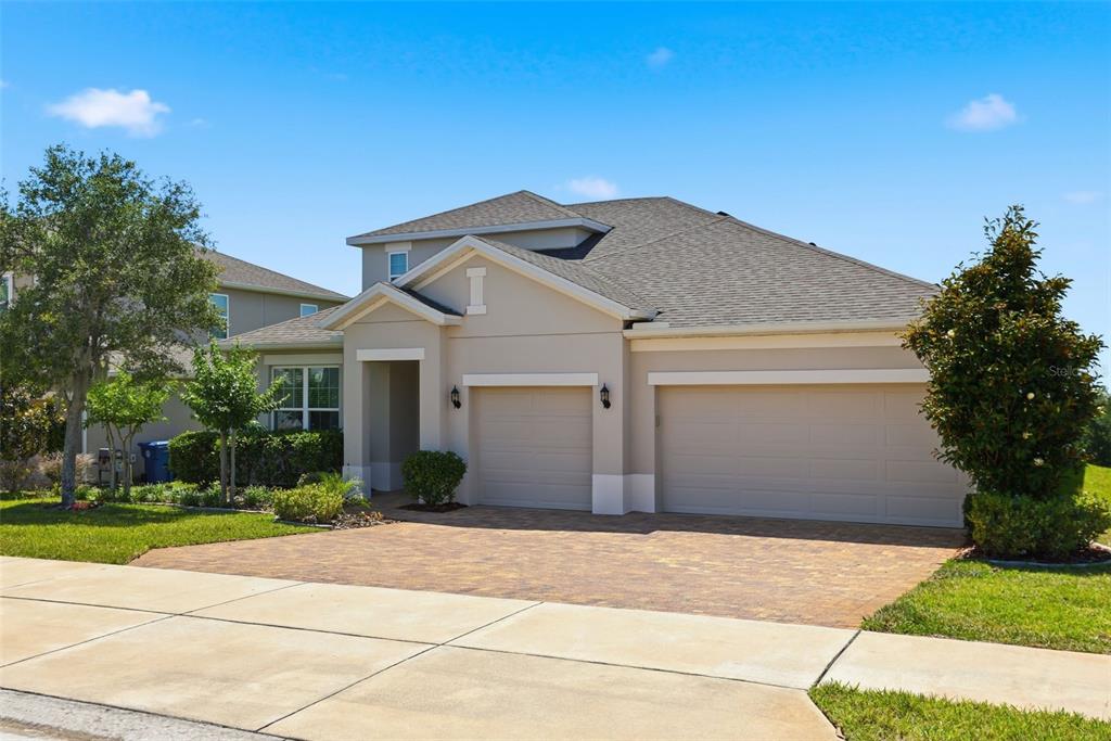 1433 Shira Road Minneola, FL 34715 - Photo 40 of 40 a front view of a house with a yard and garage