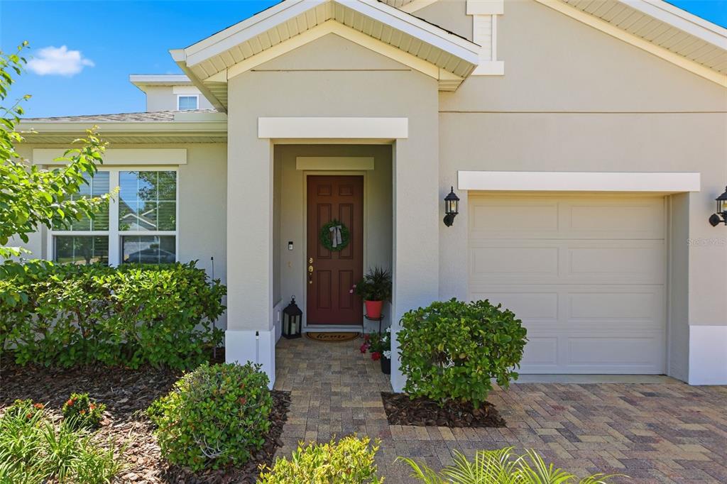1433 Shira Road Minneola, FL 34715 - Photo 6 of 40 front view of a house with potted plants