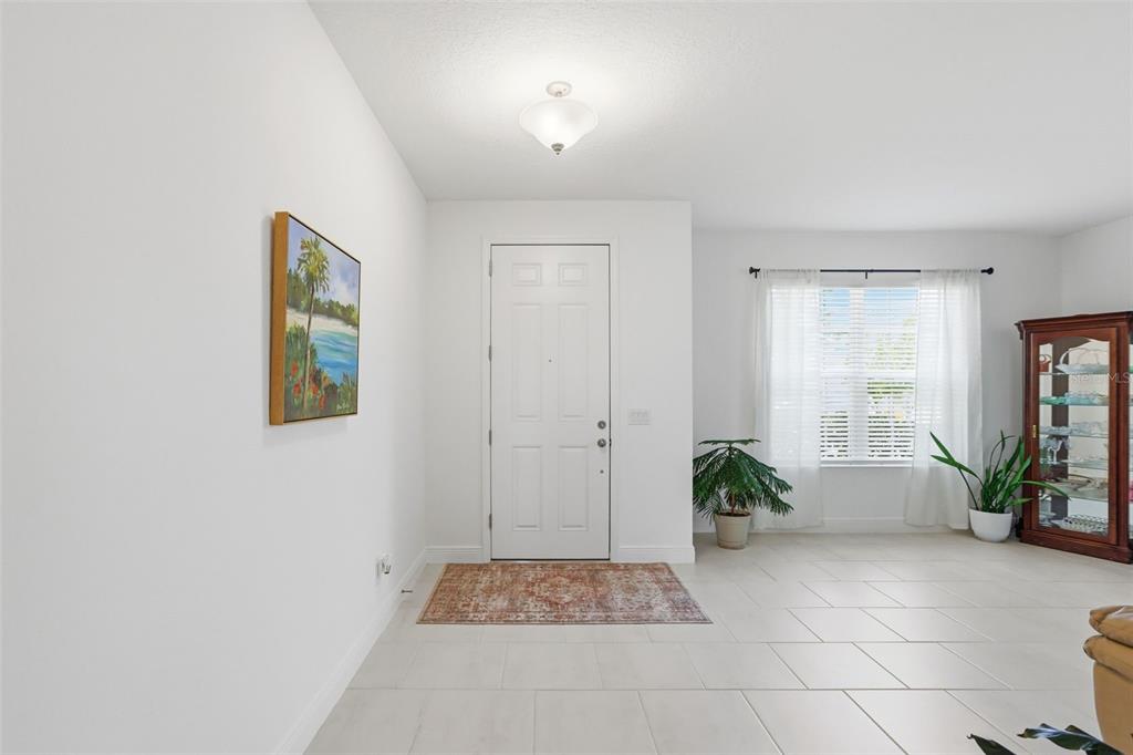 1433 Shira Road Minneola, FL 34715 - Photo 7 of 40 a view of an entryway with wooden floor