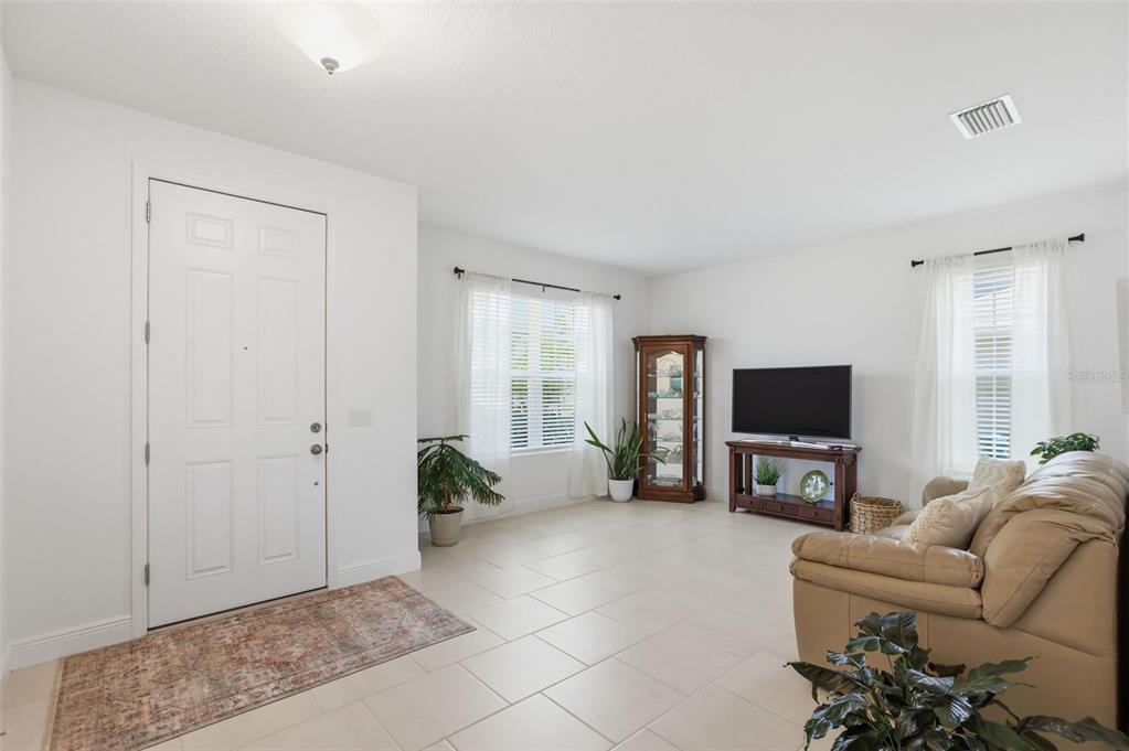 1433 Shira Road Minneola, FL 34715 - Photo 8 of 40 a living room with furniture and a flat screen tv