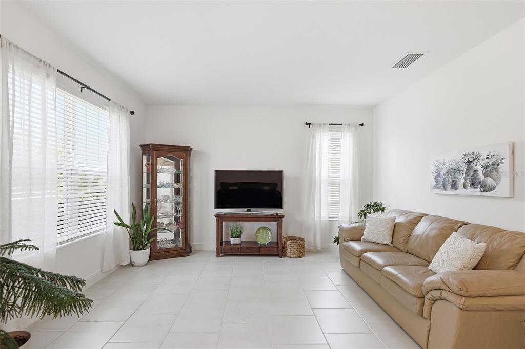 1433 Shira Road Minneola, FL 34715 - Photo 9 of 40 a living room with furniture and a flat screen tv