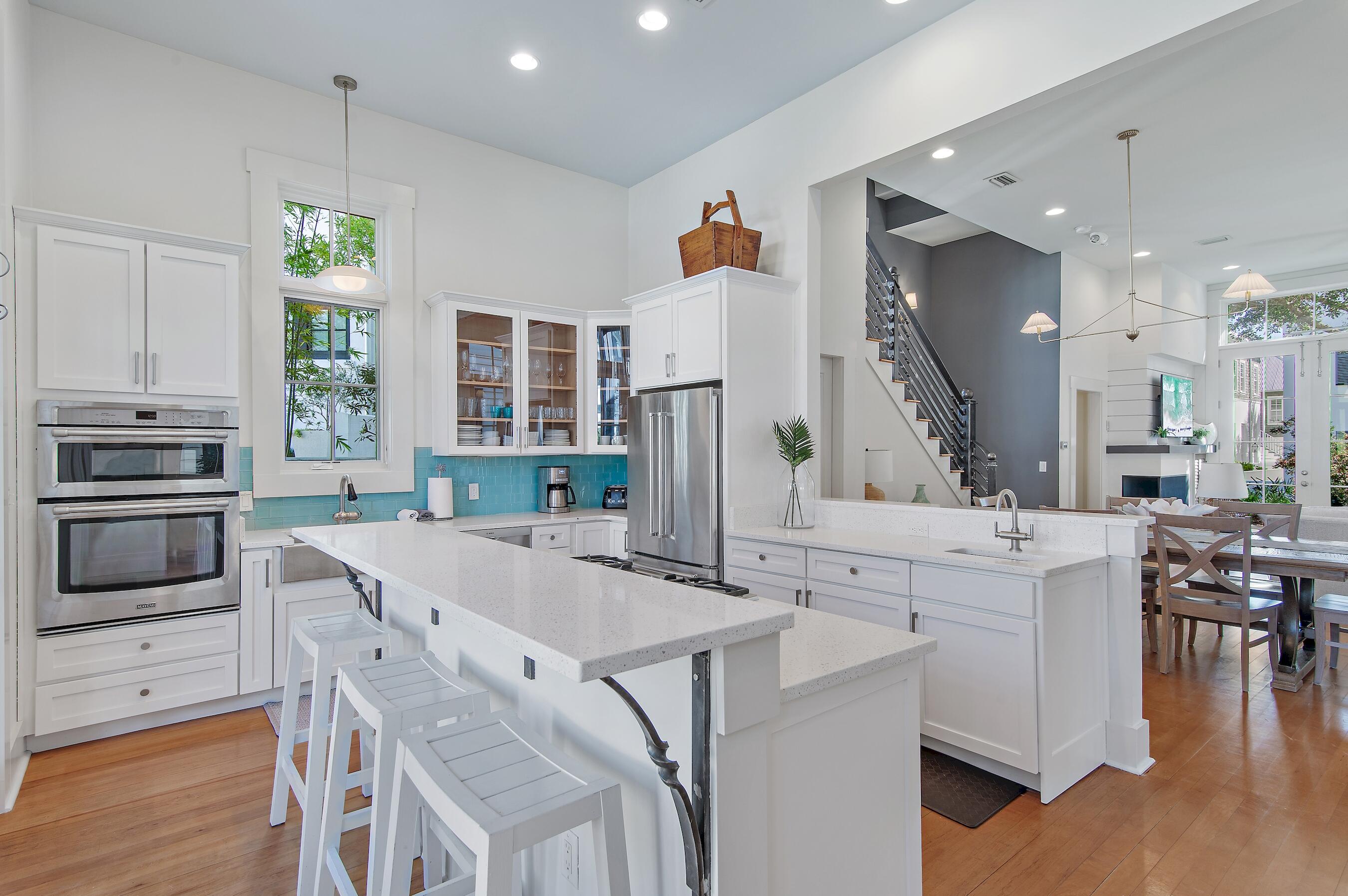 182 Kingston Road Inlet Beach, FL 32461 - Photo 11 of 55 a kitchen with kitchen island a stove a table and chairs in it