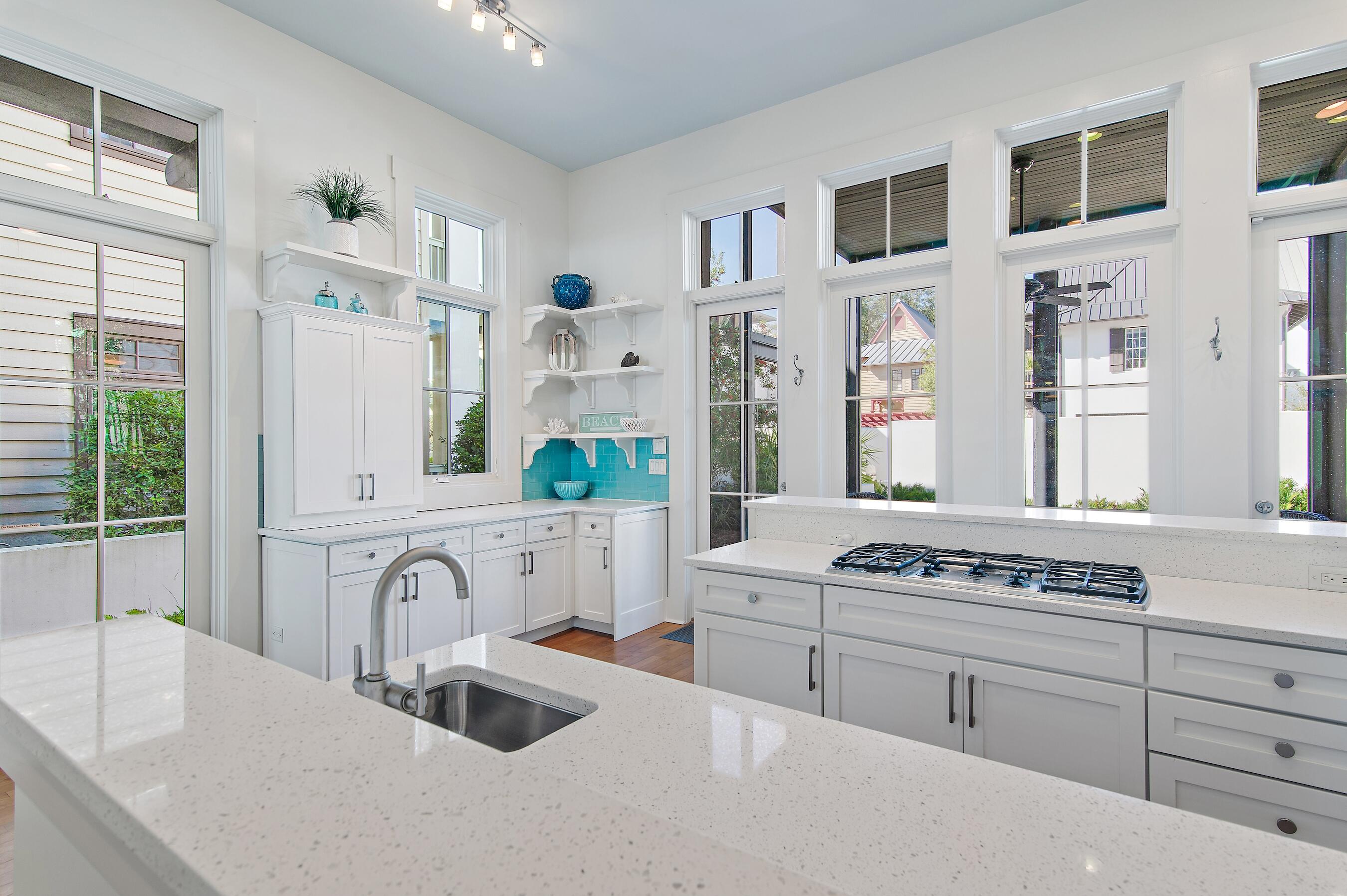 182 Kingston Road Inlet Beach, FL 32461 - Photo 12 of 55 a kitchen with stainless steel appliances granite countertop a sink stove and white cabinets