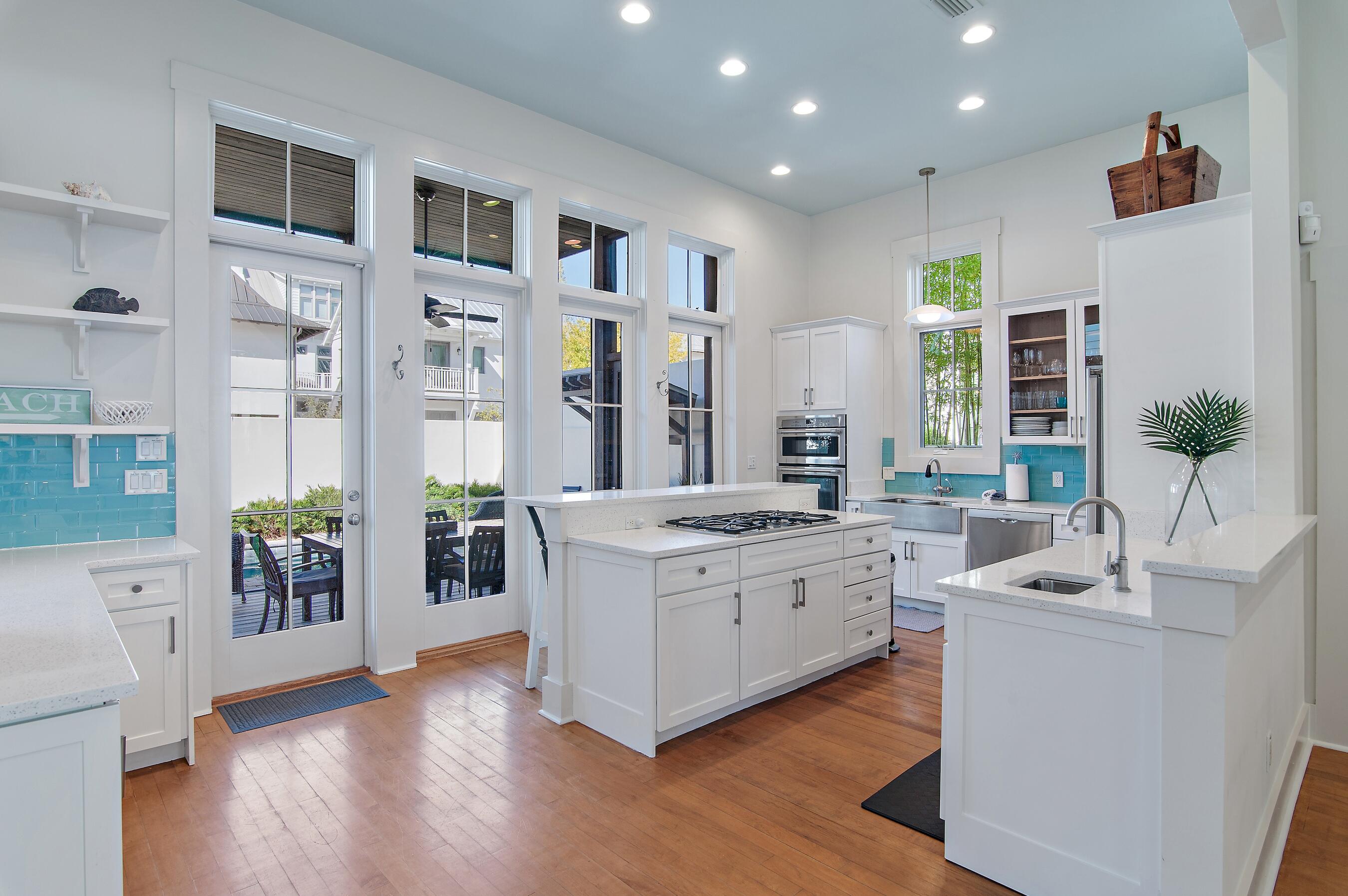 182 Kingston Road Inlet Beach, FL 32461 - Photo 14 of 55 a kitchen with stainless steel appliances granite countertop a stove and cabinets