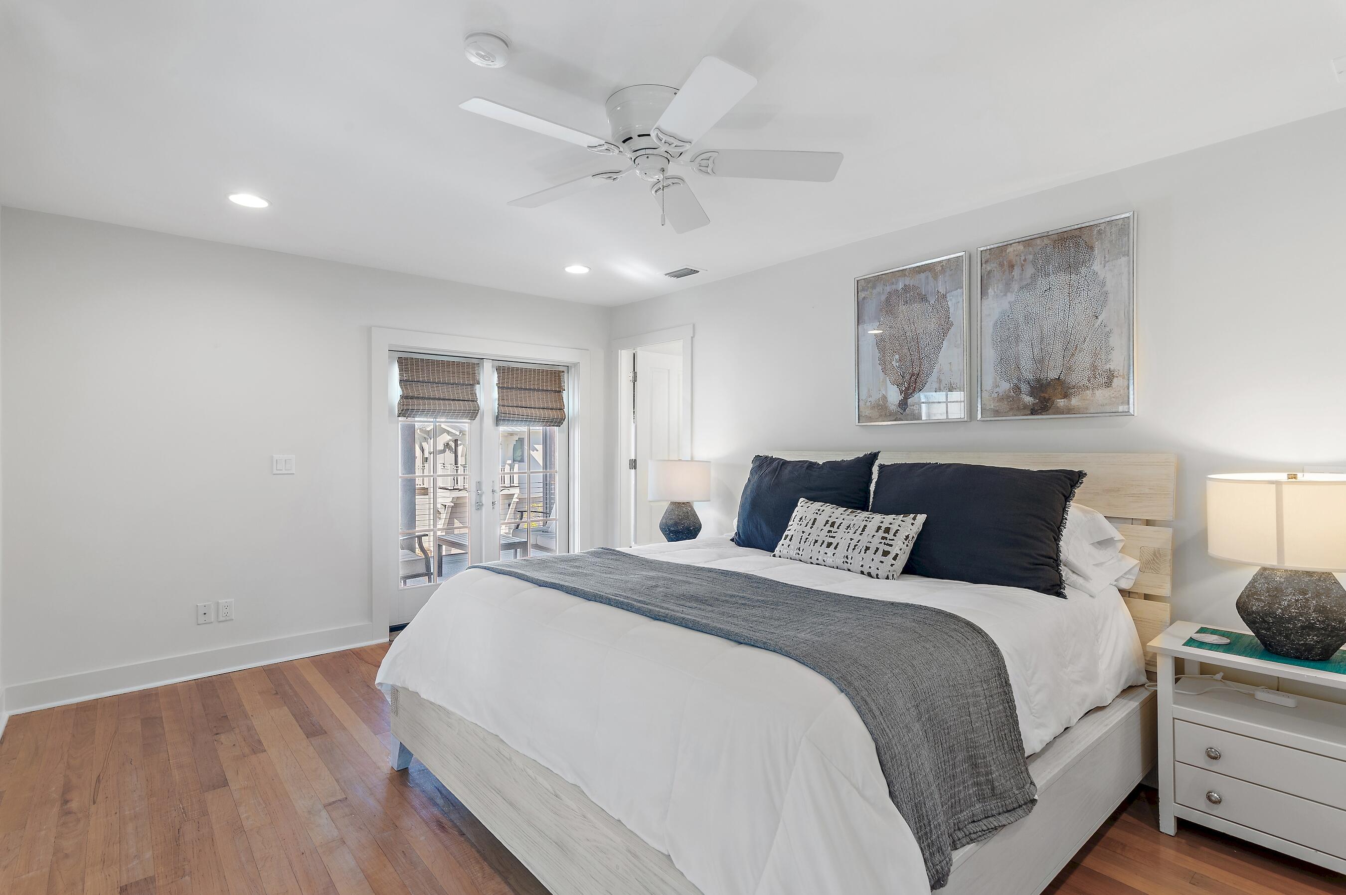 182 Kingston Road Inlet Beach, FL 32461 - Photo 22 of 55 a bedroom with a large bed and a chandelier