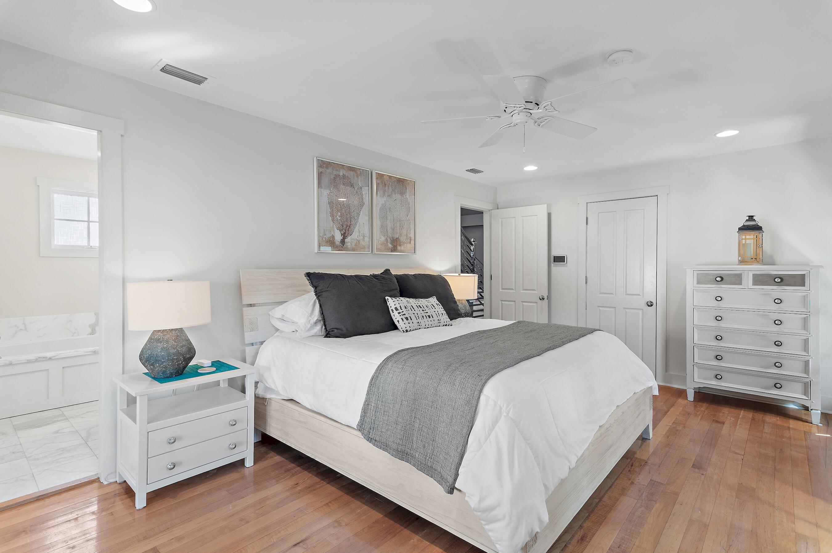 182 Kingston Road Inlet Beach, FL 32461 - Photo 23 of 55 a spacious bedroom with a bed and wooden floor