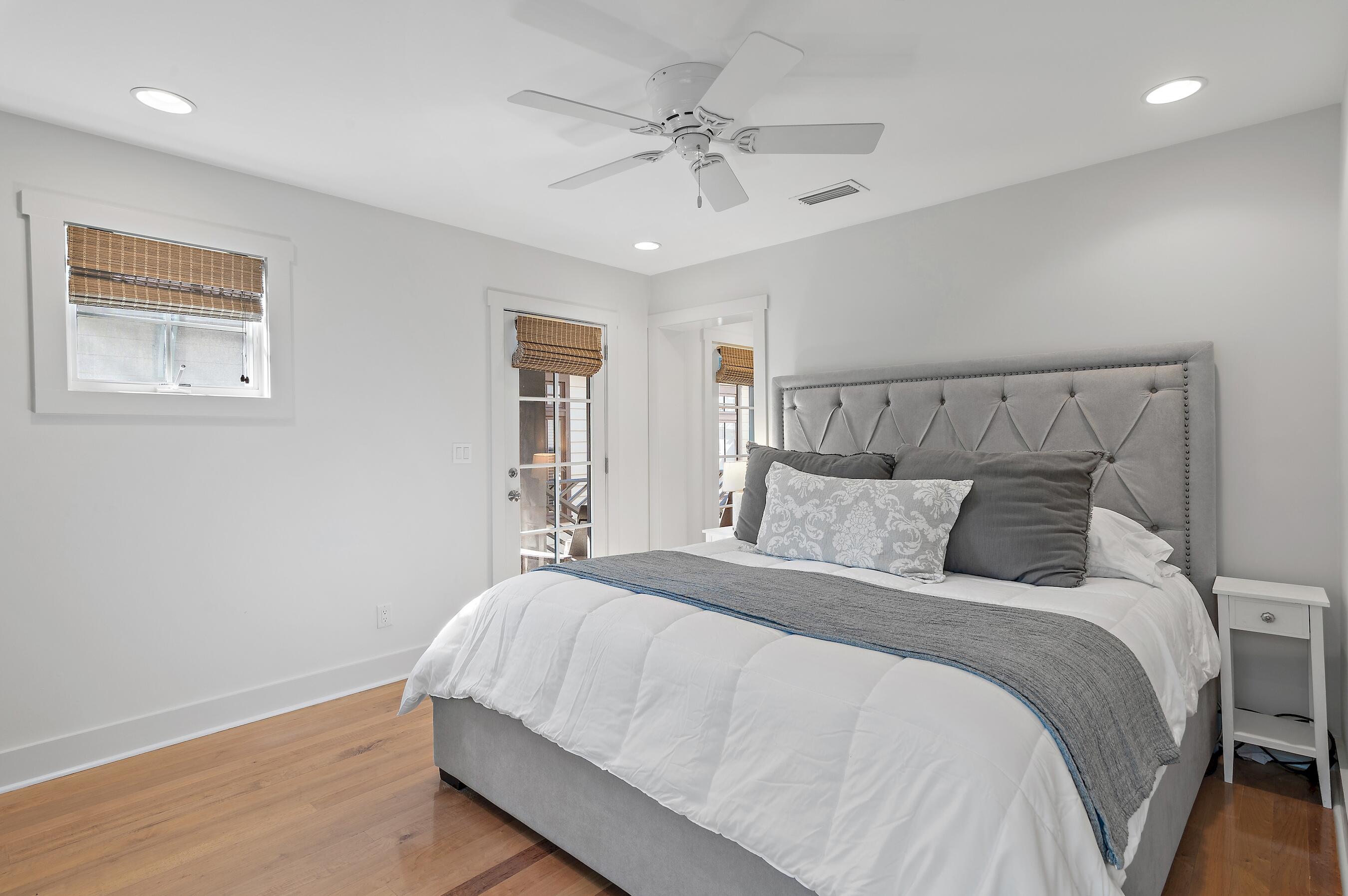 182 Kingston Road Inlet Beach, FL 32461 - Photo 27 of 55 a bedroom with a large bed and a chandelier